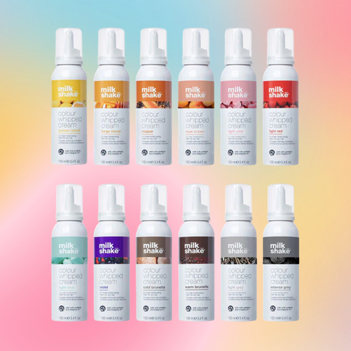 Multiple bottles of milk_shake hair products on a gradient background