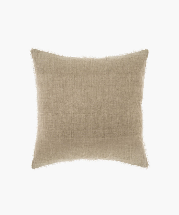 A square, beige pillow with a subtle textured fabric and frayed edges. The pillow has a minimalist, cozy appearance, suitable for neutral decor. | Wildwood Home Co.