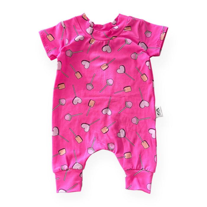 This adorable handmade romper is perfect for your little sweetie! Featuring a fun lollipop and heart design on a bright pink background, it’s as comfy as it is cute. Made for sizes preemie to 4T.