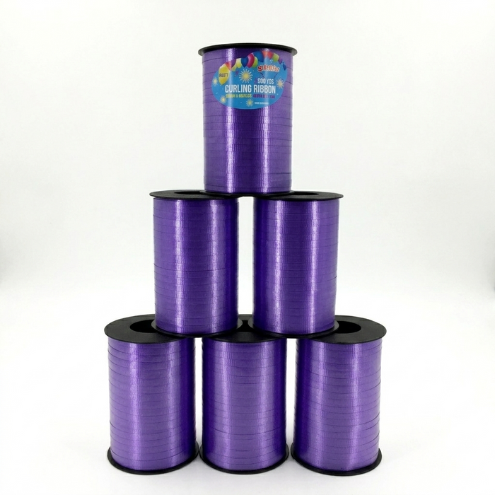 Purple curling ribbon spools stacked on a white background