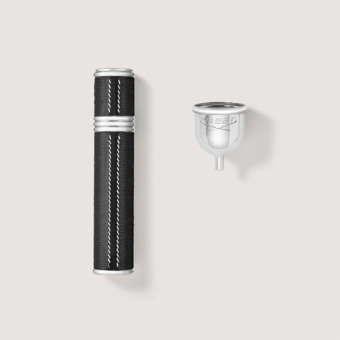 Black leather-wrapped silver 10ml Creed travel perfume atomizer with refill funnel - Flat Lay | Creed Boutique