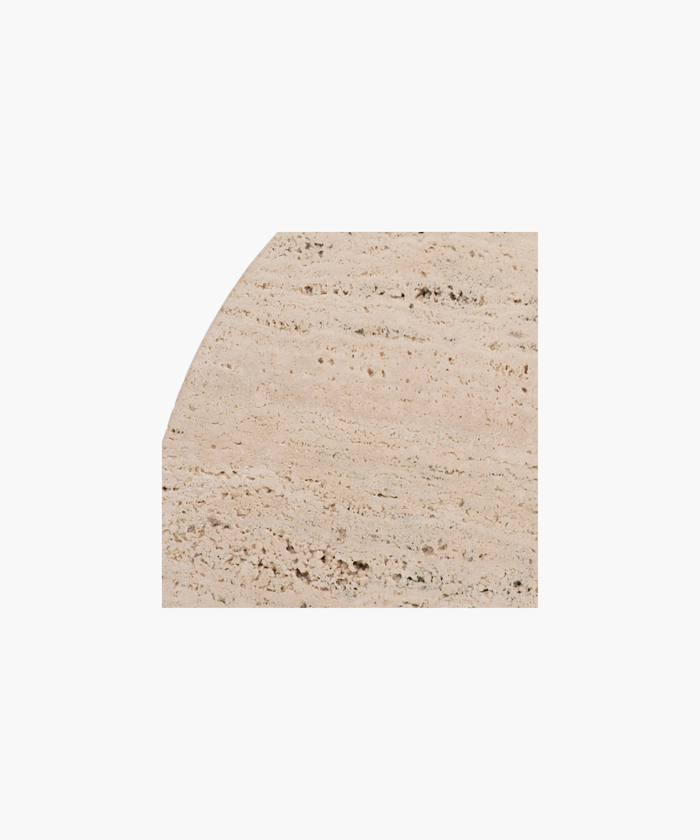 A detailed picture of one of the beige, semi-circular stone bookends highlighting the color and textured surface. | SW Home