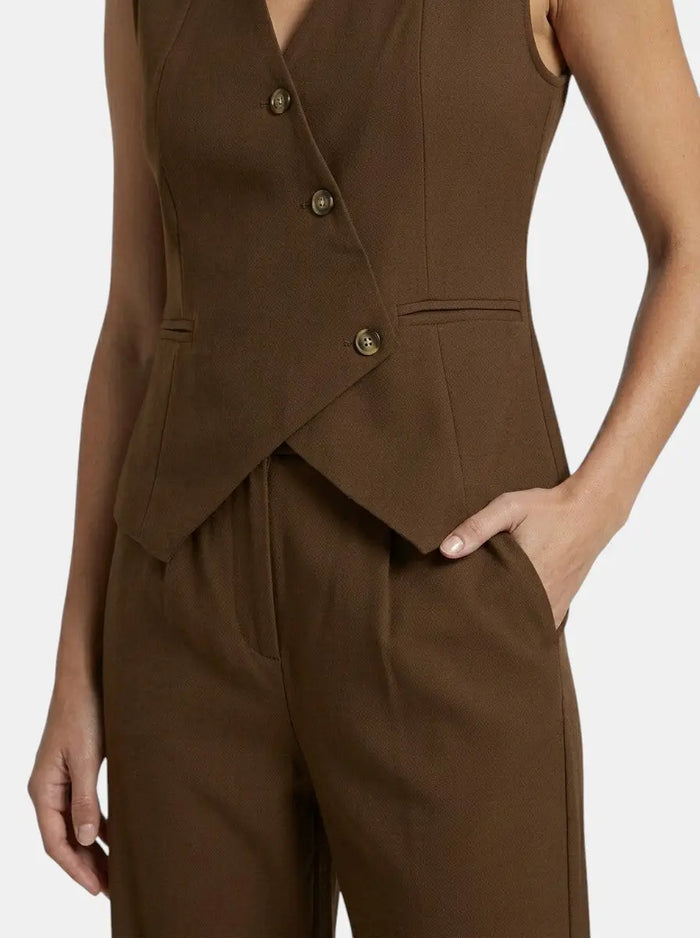 Women's tailored fabric suit set featuring an elegant sleeveless blazer and wide-leg trousers, perfect for professional or formal wear.