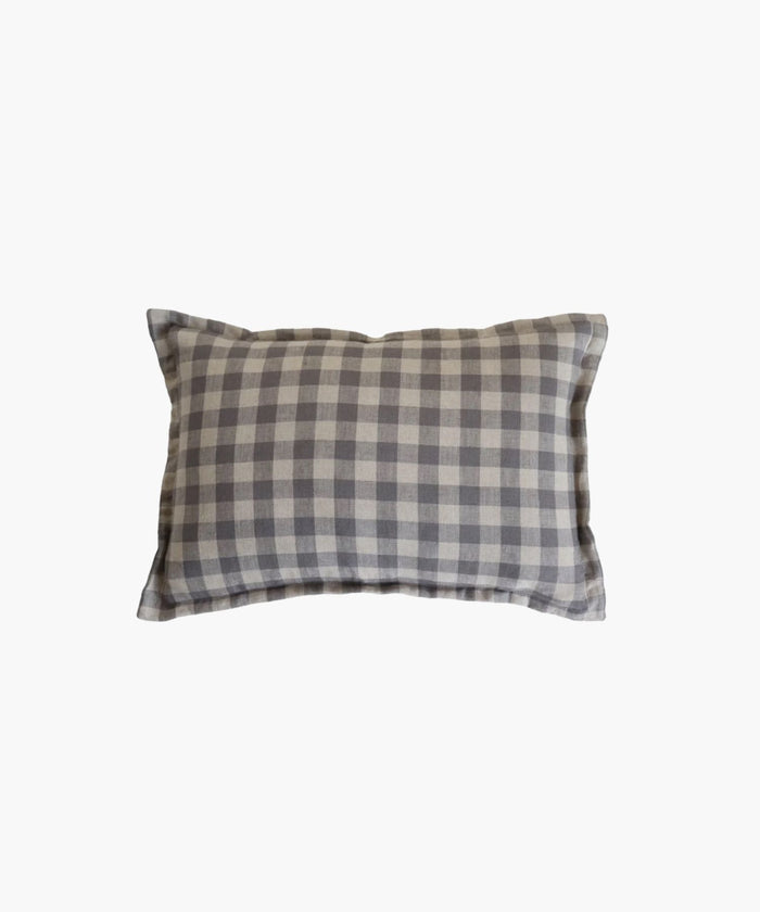 A rectangular or lumbar pillow cover features a blue gray gingham pattern on a natural fabric printed on both sides conveying a cozy and rustic feel. | Wildwood Home Co.