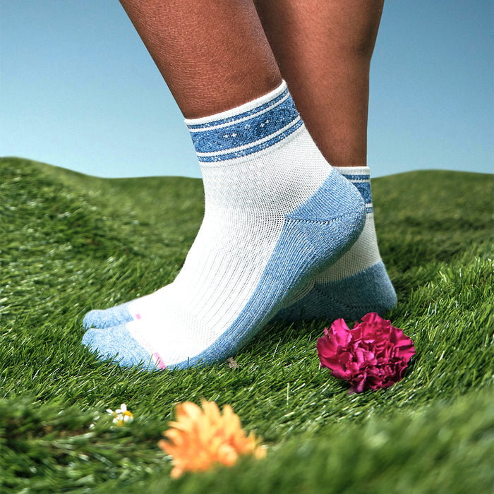 Quarter compression socks with a blue and white bandana stripe design, set against a grassy background.