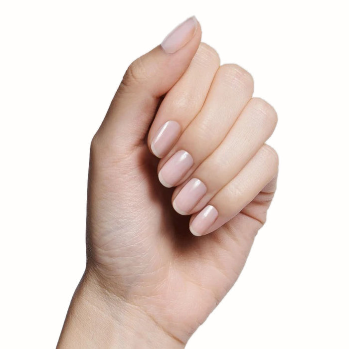 Hand with nails polished in sheer milky white BEB gel polish showing a fresh, natural mani look
