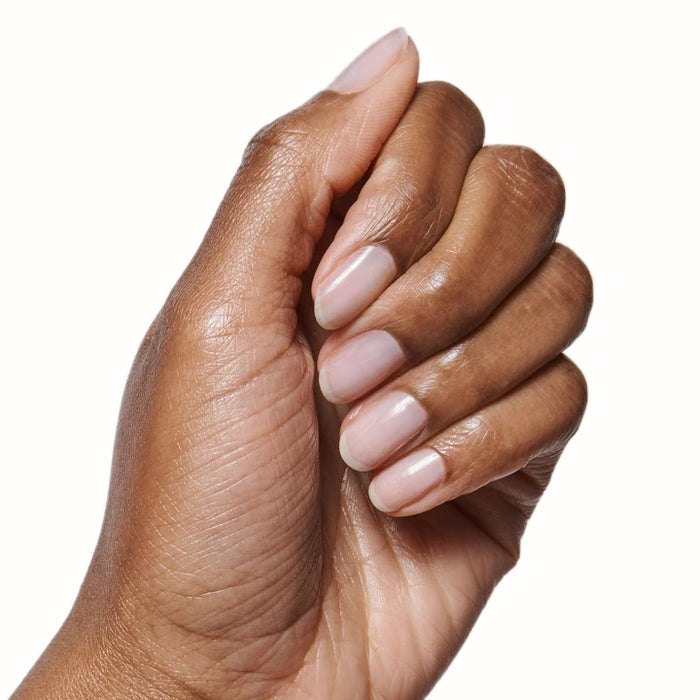 Hand with nails coated in sheer BEB gel polish showing a subtle, fresh manicure on natural skin tone