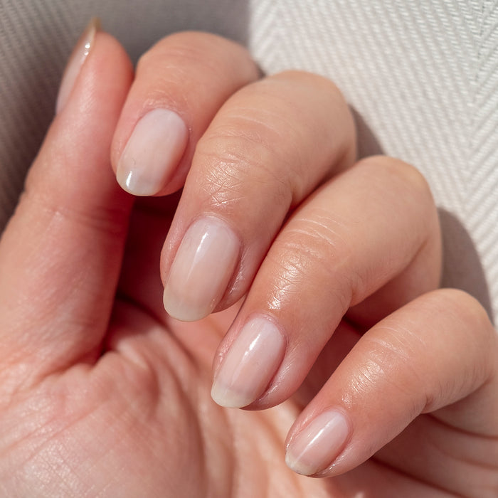 Hand displaying a natural mani with sheer BEB gel polish for a delicate and fresh finish on fair skin tone