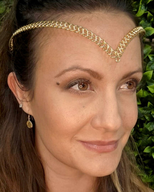 Model wearing a gold braided wire crown headband with a V-shaped front design.