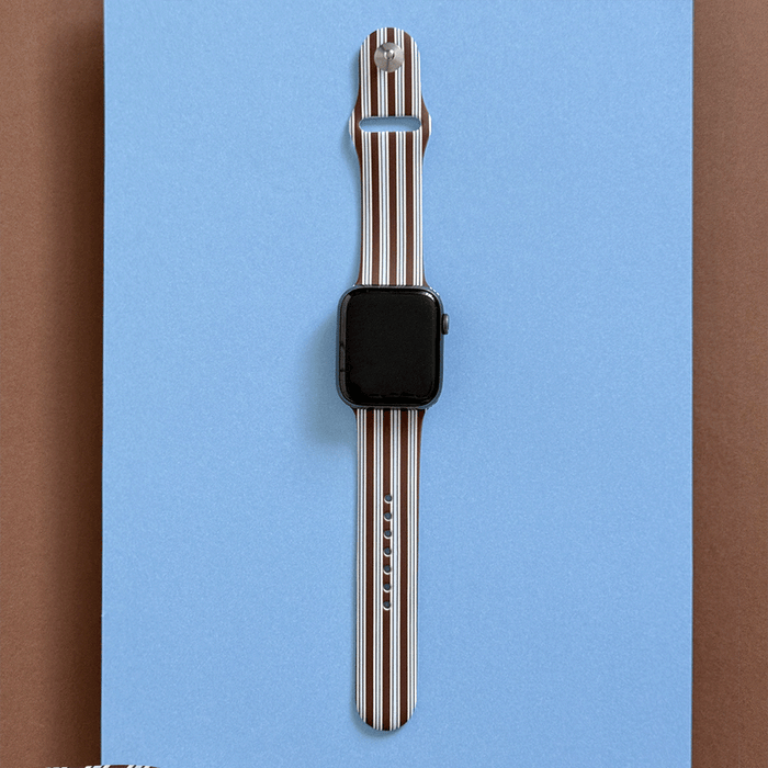 Apple Watch Strap with brown and white vertical stripes on a blue background.