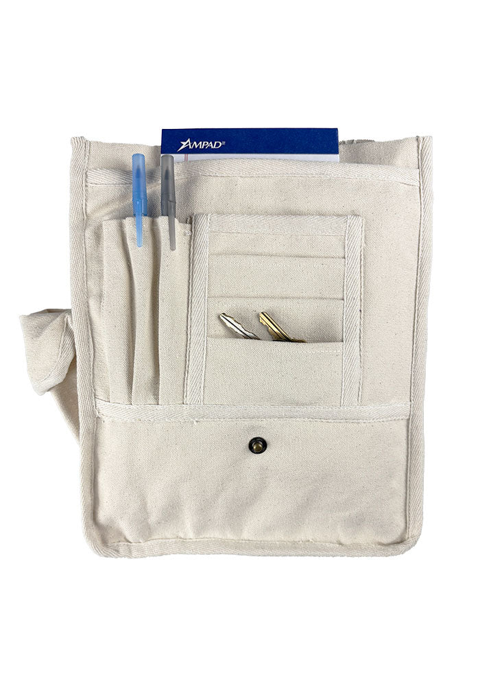 Inside view of canvas bag with sewn compartments for cards, keys, pens, and a larger space for notebook sized items.