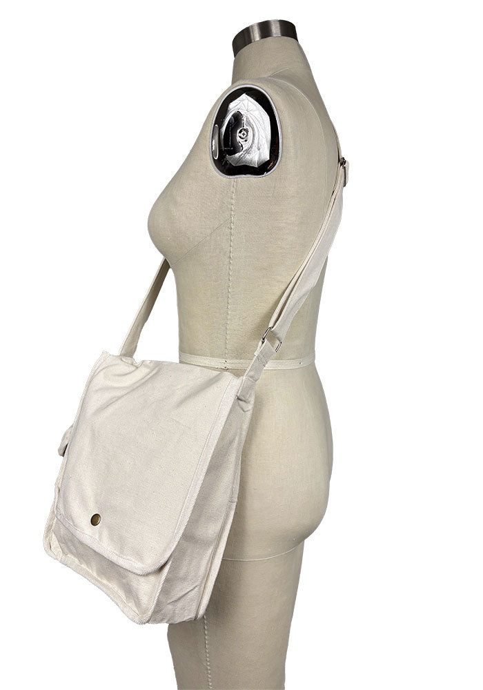 Side view of canvas bag displayed on a mannequin against a plain background.
