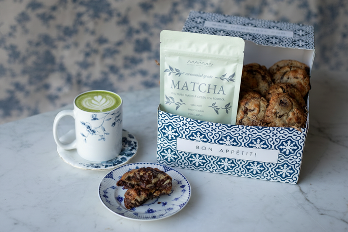 light green maman matcha powder pouch placed inside a maman cookie gift box.