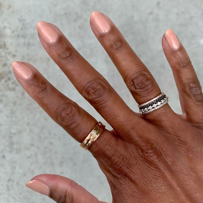 Hand with nails painted in CHM sheer tan gel polish showcasing a flattering and versatile manicure by Olive and June