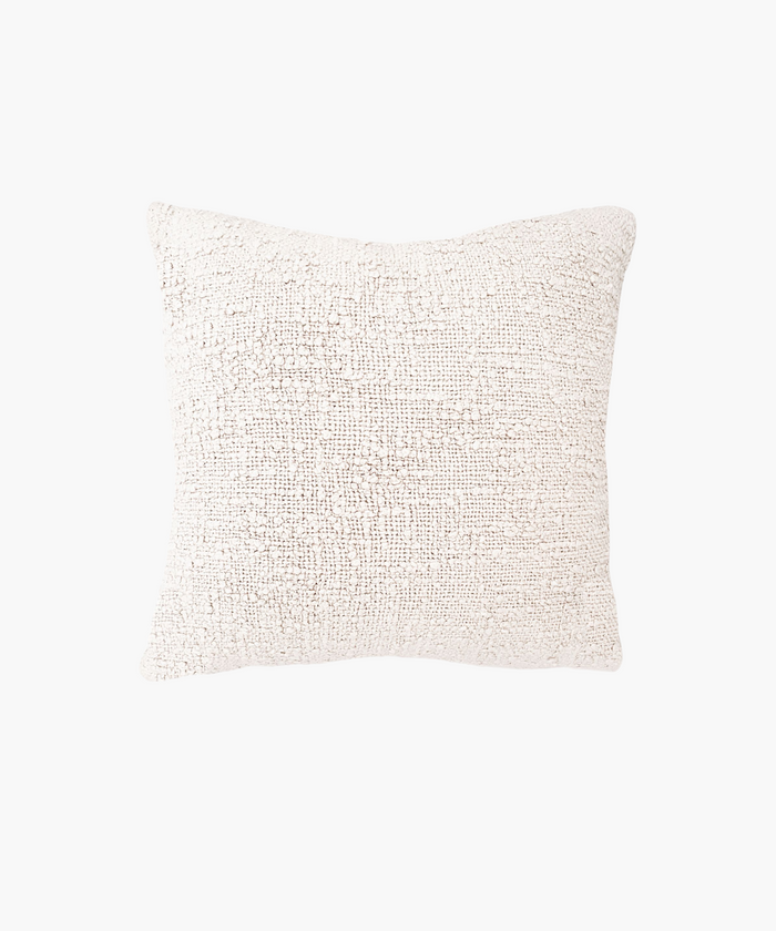 A textured square pillow in a soft ivory color, featuring a woven boucle pattern. The design gives a cozy, inviting feel, ideal for home decor. | Wildwood Home Co.