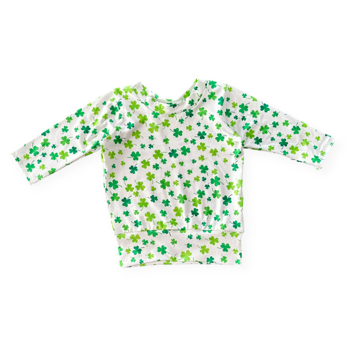 Handmade white lounge top with green shamrock print for babies and toddlers. Perfect for St. Patrick's Day festivities and comfortable everyday wear. Sizes NB to 4T.