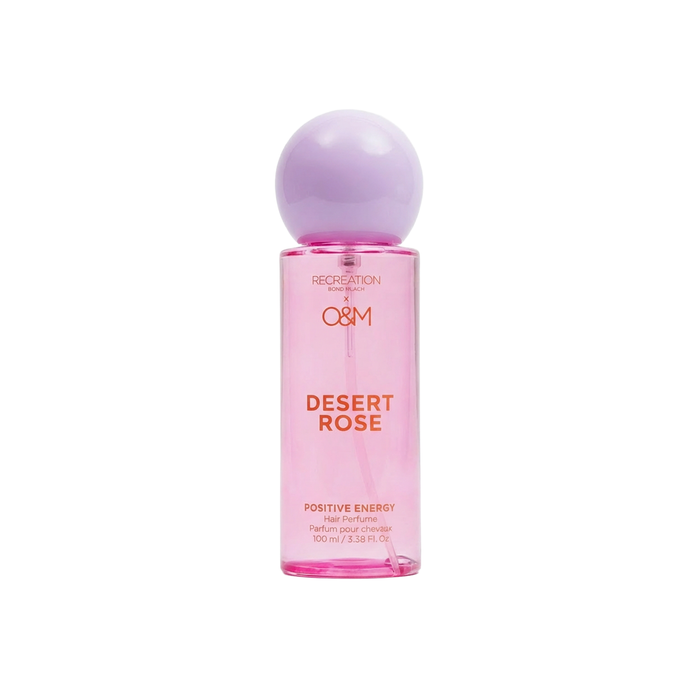 Perfume bottle labeled 'Desert Rose' with a pink body and purple cap on a white background