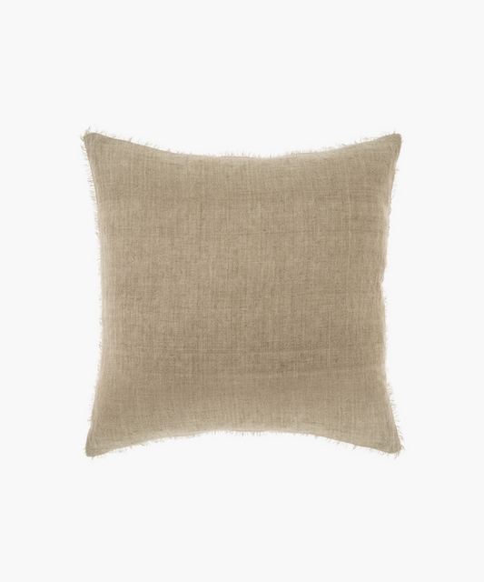 A square, beige pillow with a subtle textured fabric and frayed edges. The pillow has a minimalist, cozy appearance, suitable for neutral decor. | Wildwood Home Co.