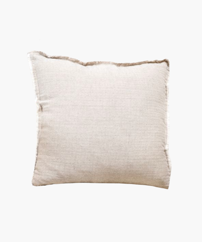 A beige linen pillow cover with frayed edges on a white background. | SW Home