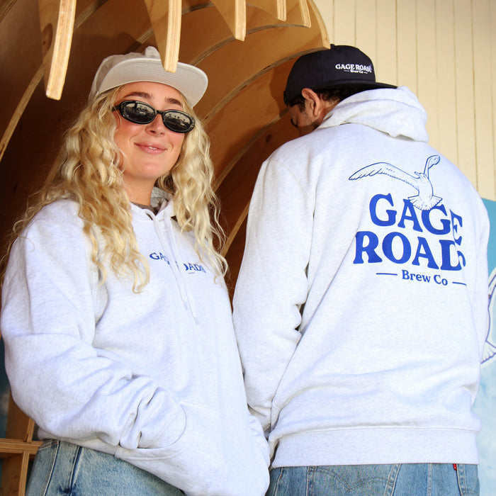 Two people wearing white hoodies with 'Gage Road Brew Co' branding, standing close together.