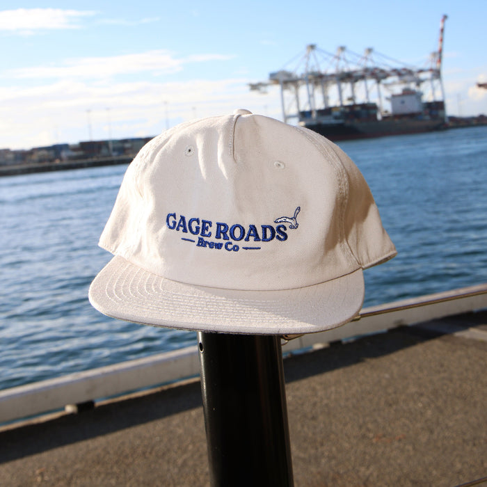 White cap with 'Gage Roads Brew Co' logo against a waterfront background with ships.