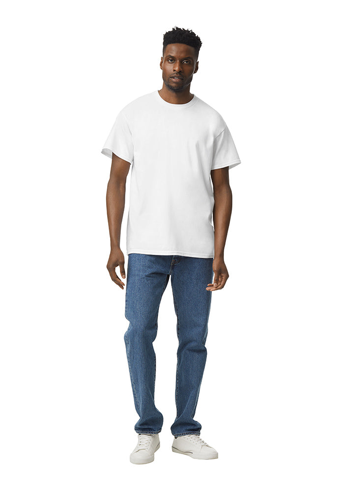 Man wearing a white Gildan 5.3oz. Cotton Short Sleeve T-shirt and blue jeans on a white background.