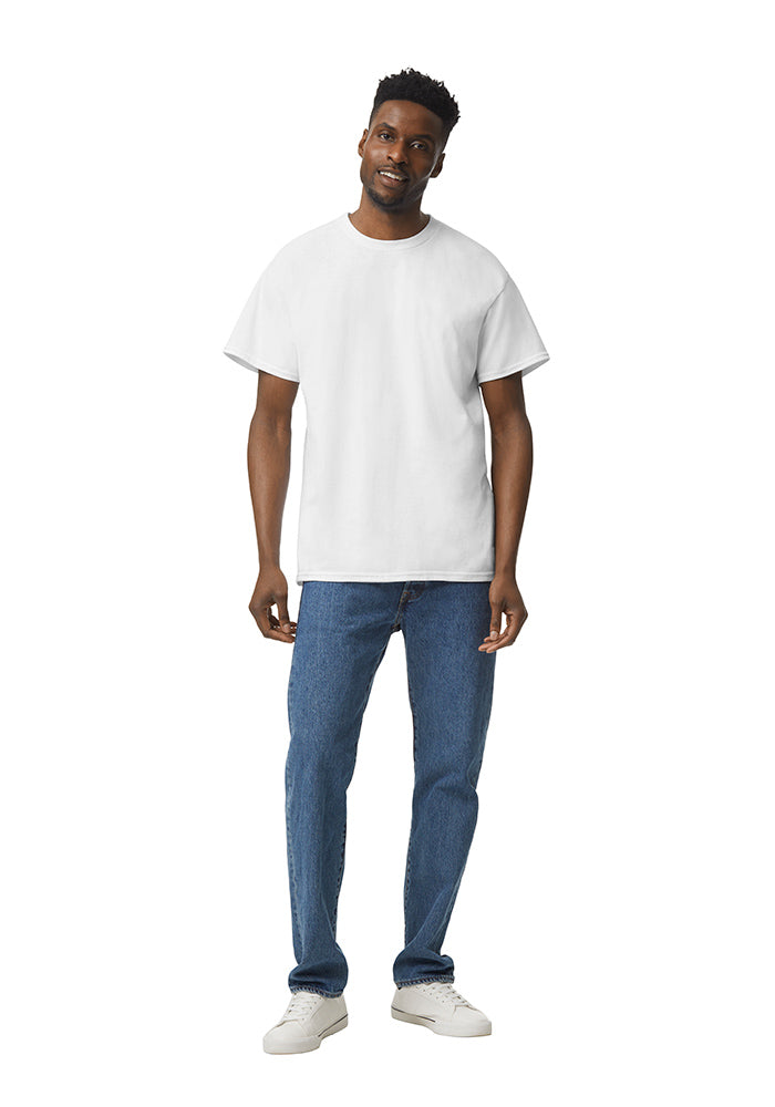 Man wearing a white Gildan 5.3oz. Cotton Short Sleeve T-shirt and blue jeans on a white background.