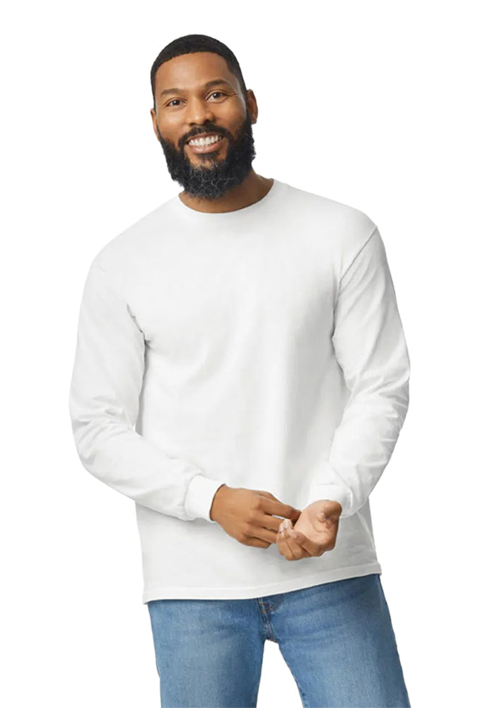 Smiling man wearing a Gildan 5.3oz. Cotton Long Sleeve T-shirt and blue jeans on a white background.