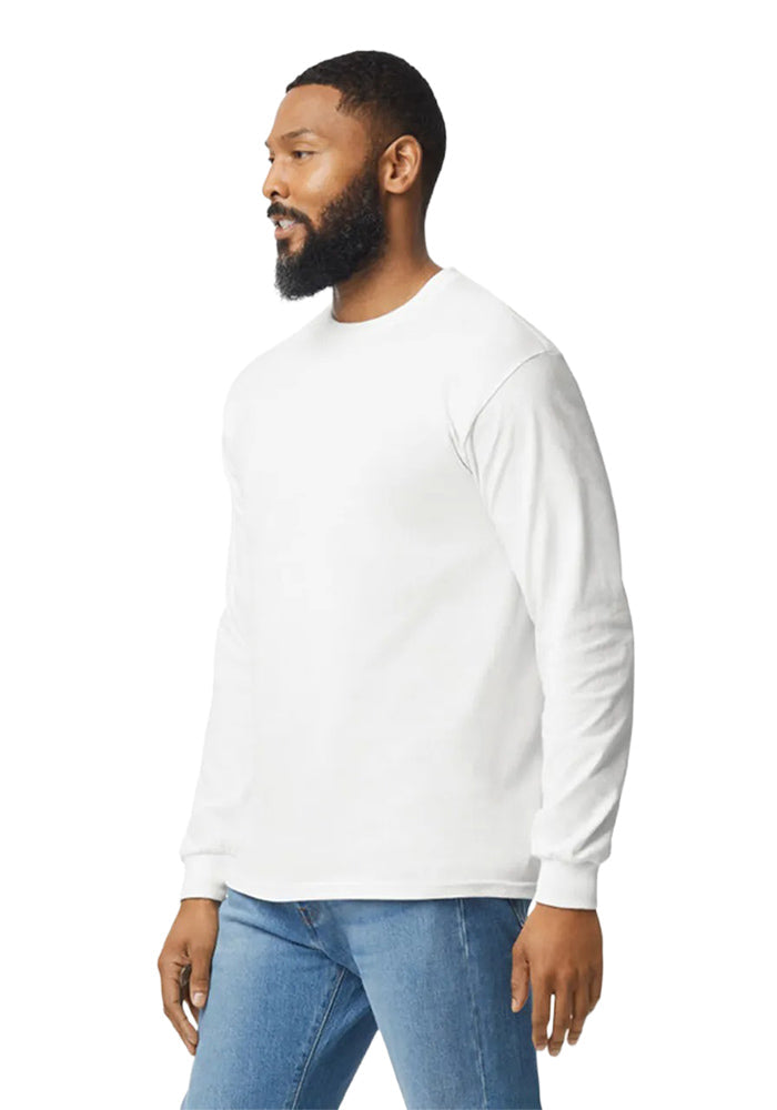 Side view of man wearing a Gildan 5.3oz. Cotton Long Sleeve T-shirt and blue jeans on a white background.