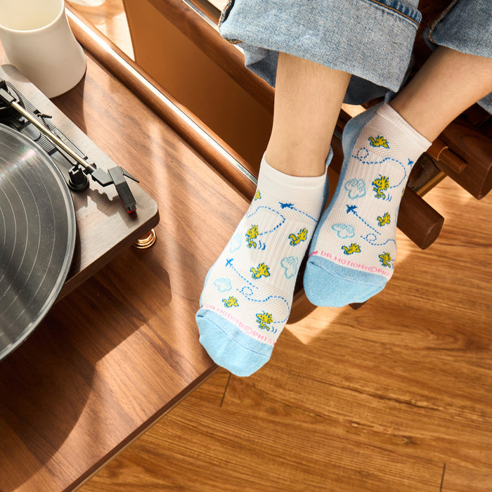 Ankle socks with a light blue and white design featuring clouds and cartoon characters.