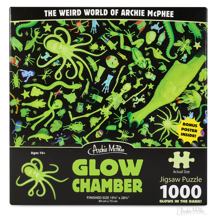 The Glow Chamber Puzzle is a captivating 1000-piece jigsaw box featuring ghostly green objects against a striking black background.