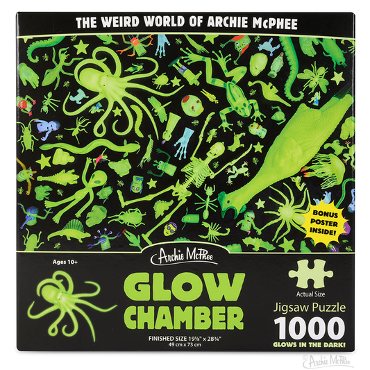 The Glow Chamber Puzzle is a captivating 1000-piece jigsaw box featuring ghostly green objects against a striking black background.