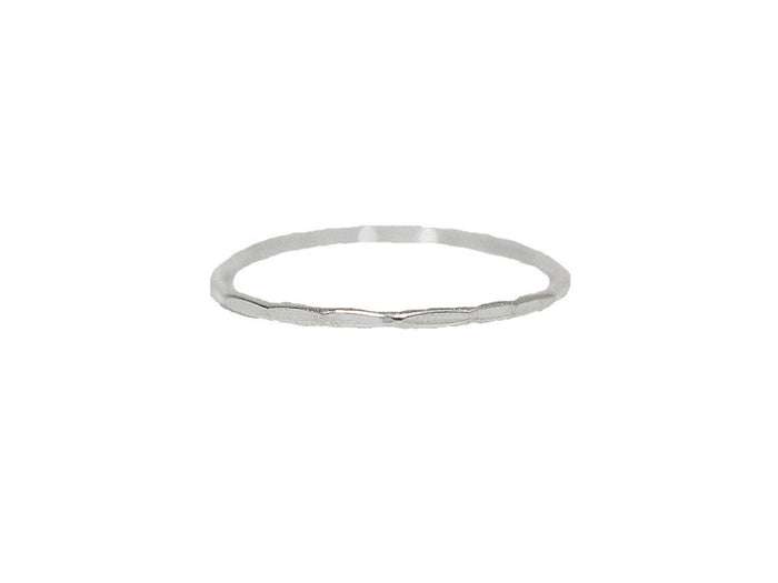 Hammered thin band ring in sterling silver with subtle textured finish, isolated on white background