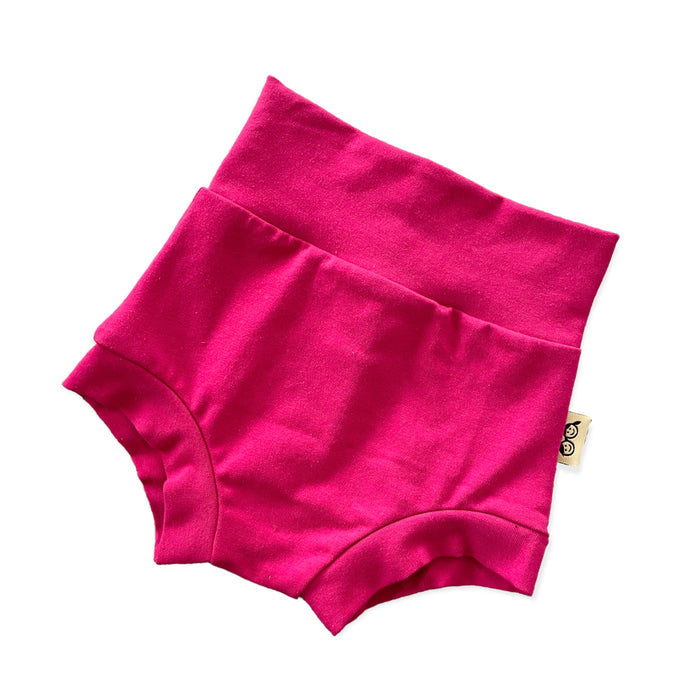 Handmade hot pink baby bummies with a fold-over waistband, displayed flat on a white background. Soft, stretchy, and comfortable for newborns, infants, and toddlers. Perfect for warm weather, layering over diapers, or pairing with bodysuits and tops. Available in sizes preemie to 4T.