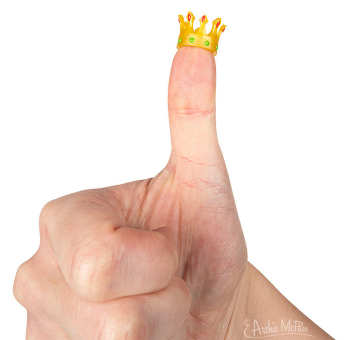 A thumb wearing an Itty Bitty Crowns product gives a thumbs-up against a white background.