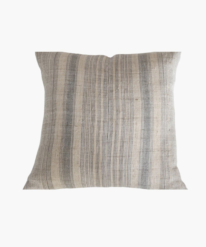 A square pillow cover with a neutral hemp background features vertical grey and blue stripes. The texture appears soft and slightly textured, conveying a cozy and rustic feel. | SW Home