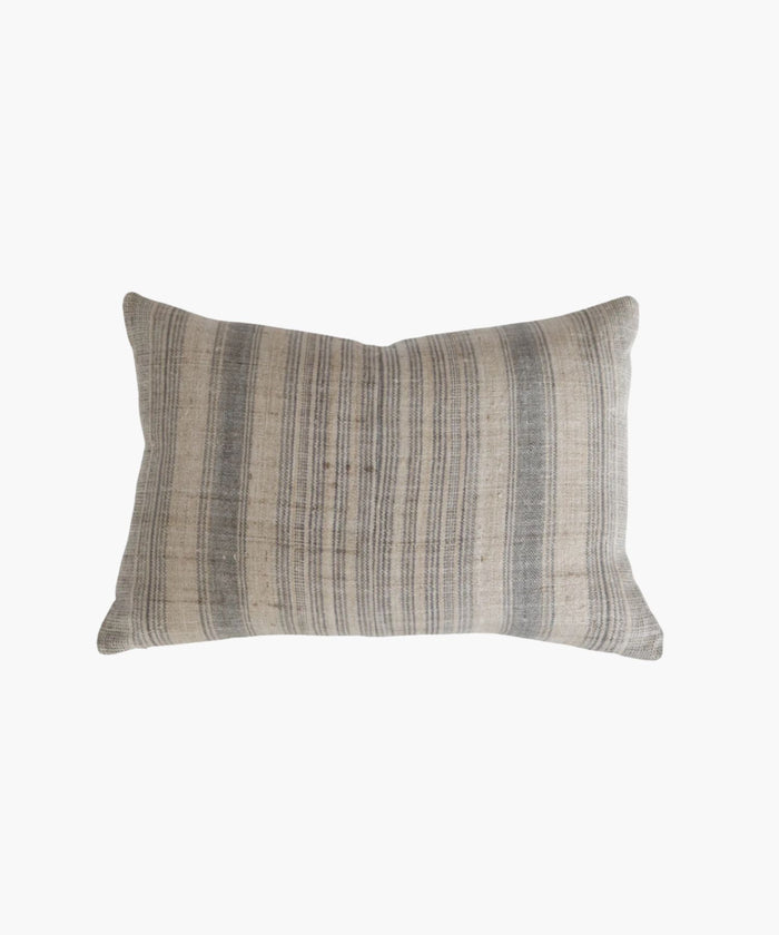 A rectangular or lumbar pillow cover with a neutral hemp background features vertical grey and blue stripes. The texture appears soft and slightly textured, conveying a cozy and rustic feel. | SW Home