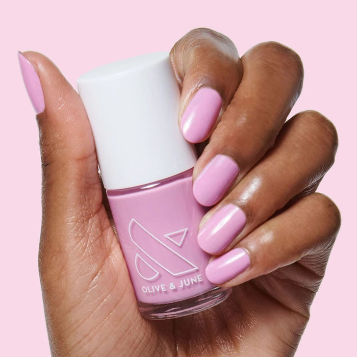 Hand with nails polished in JM pinky lavender gel polish for a smooth and elegant manicure by Olive and June