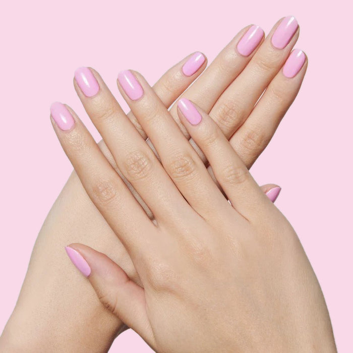 Hands with nails polished in JM pinky lavender gel polish for a smooth and pretty mani by Olive and June