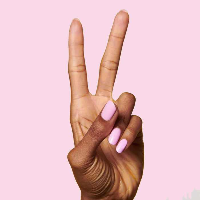 Hand showing peace sign with nails polished in JM pinky lavender gel polish by Olive and June