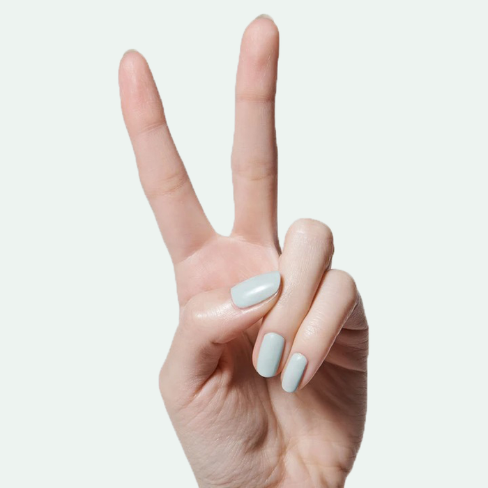 Hand showing two fingers with smooth, sage green KMC gel polish for a fresh at-home manicure look