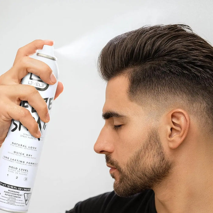 Man using a Level 3 hair spray can with a plain background