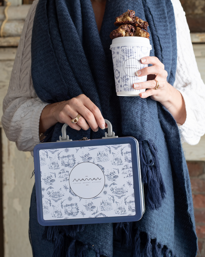 Blue and white toile tin lunch box with the round "maman" logo on top.