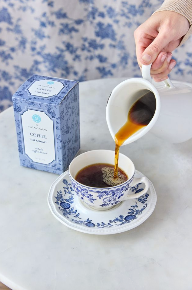Person pouring dark roast coffee from the Martha Stewart x Maman collection into a cup.