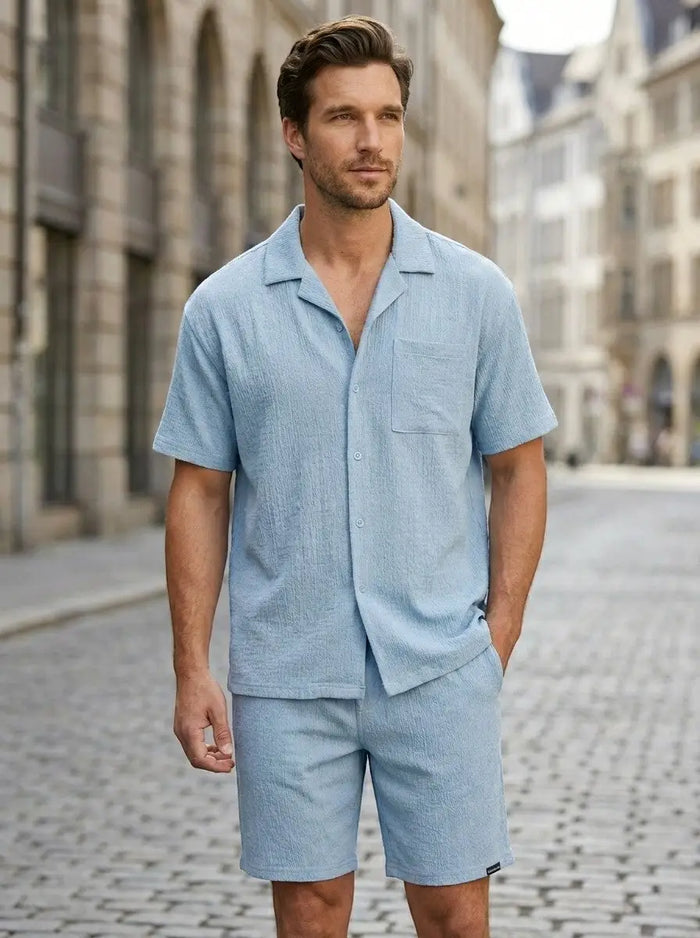 Men's crinkle fabric two-piece set with relaxed camp collar shirt and elasticated waist shorts, stylish and comfortable.