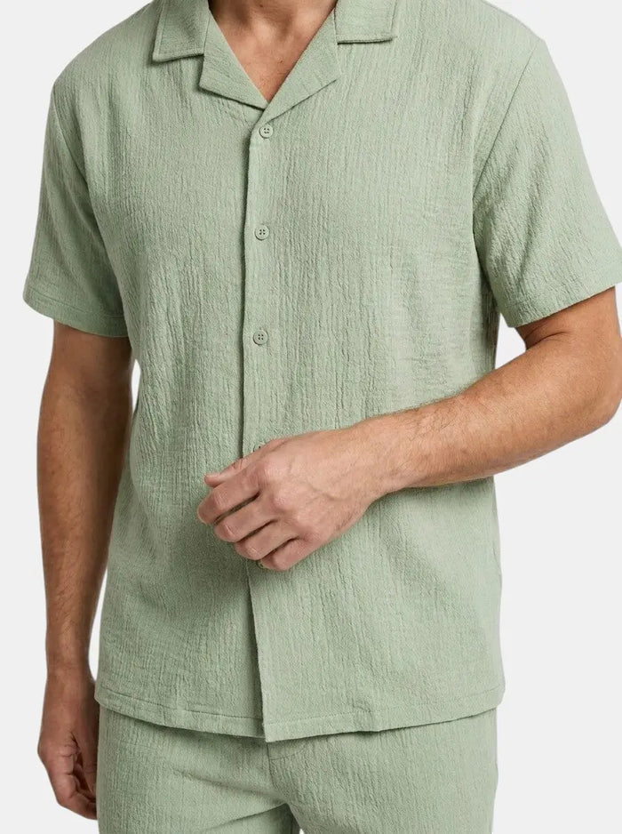 Men's crinkle fabric two-piece set with relaxed camp collar shirt and elasticated waist shorts, casual and comfortable for summer wear.