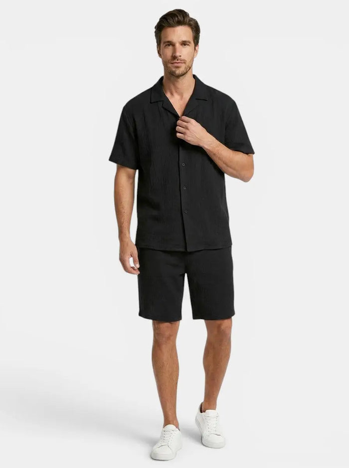 Men's crinkle fabric two-piece set with relaxed camp collar shirt and elasticated waist shorts, stylish and comfortable.