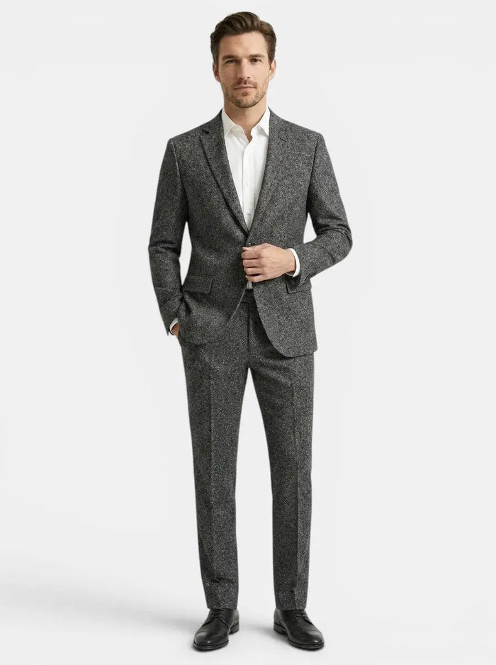 Men's slim fit two-piece suit made from smooth suiting blend, featuring a tailored jacket and matching trousers in a formal style.