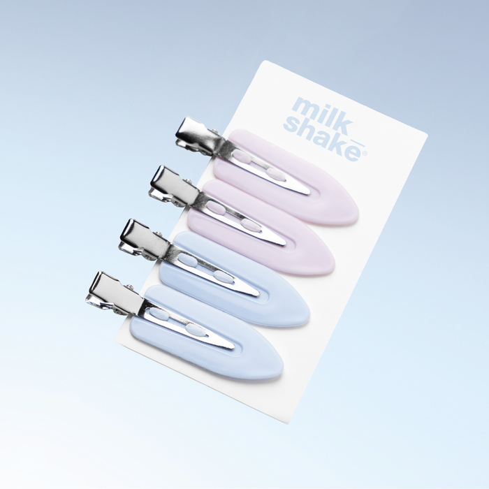 Set of four pastel-coloured hair clips on a 'milk shake' branded card against a light blue background.