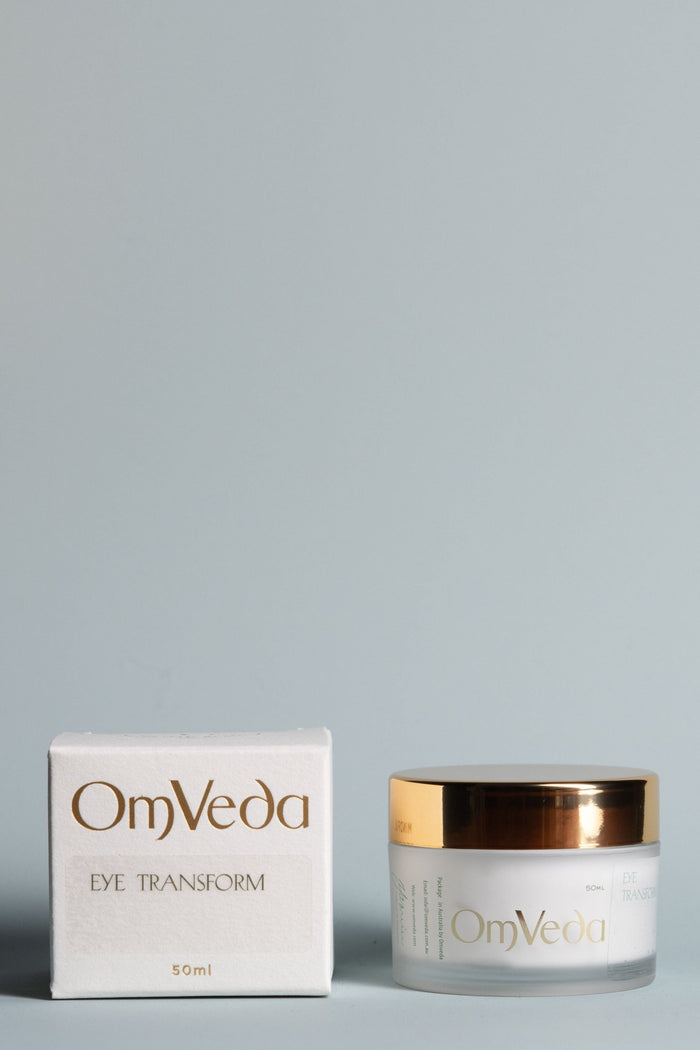 OmVeda Eye Transform skincare cream jar with gold lid and product box, 50ml